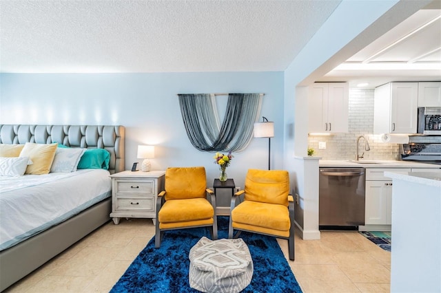 bedroom featuring light tile patterned flooring, sink, and a textured ceiling