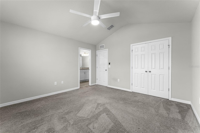 unfurnished bedroom with carpet floors, baseboards, visible vents, and vaulted ceiling