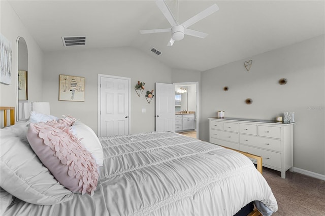 carpeted bedroom featuring a ceiling fan, visible vents, vaulted ceiling, and ensuite bath