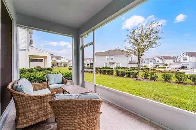 sunroom / solarium featuring a residential view