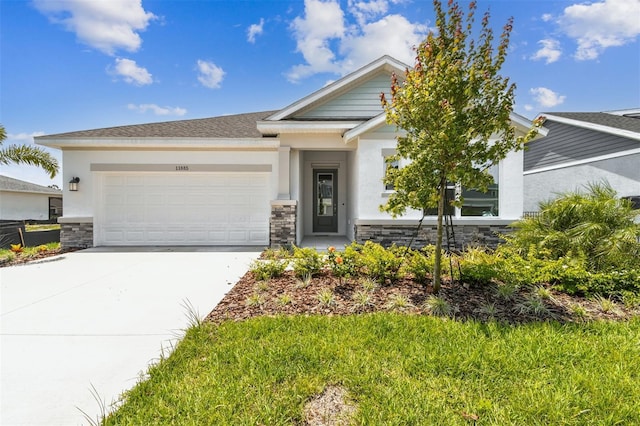 11885 Richmond Trl, Parrish, FL 34219 - view of front of house featuring stone siding, an attached garage, and stucco siding