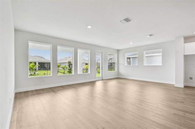 11885 Richmond Trl, Parrish, FL 34219 - unfurnished living room featuring baseboards, light wood-style flooring, and recessed lighting