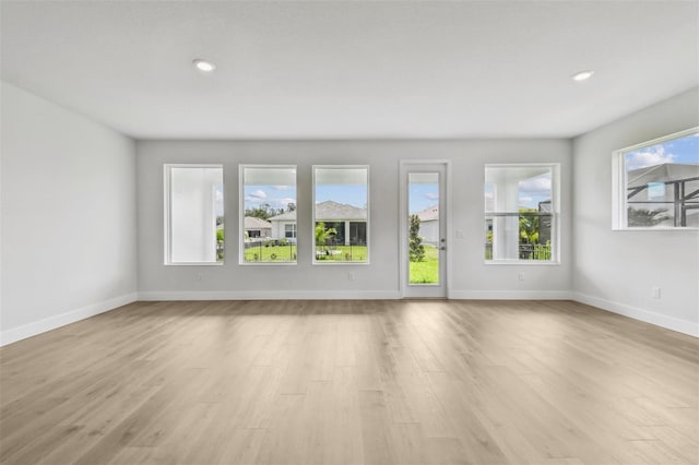 11885 Richmond Trl, Parrish, FL 34219 - unfurnished living room with light wood-type flooring, baseboards, and recessed lighting