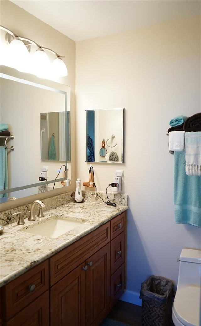 bathroom featuring vanity and toilet