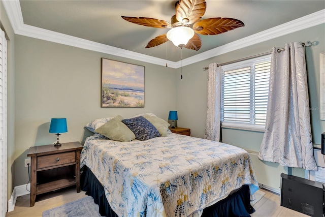 bedroom with light wood-type flooring, baseboards, ornamental molding, and a ceiling fan