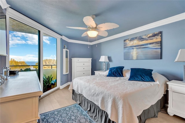 bedroom featuring baseboards, ceiling fan, crown molding, light wood-style floors, and floor to ceiling windows