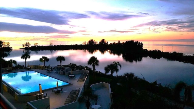 view of pool with a water view