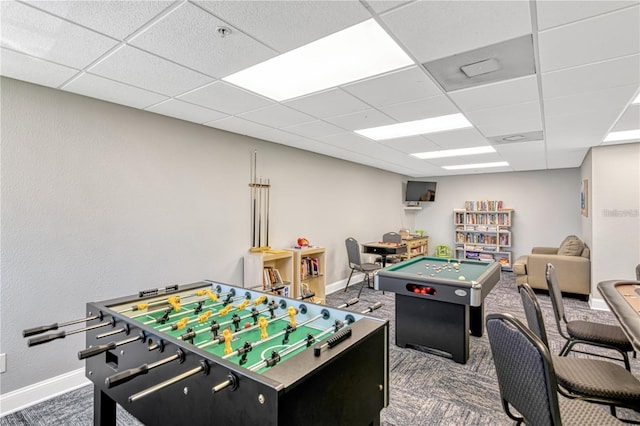 playroom with carpet, baseboards, and a drop ceiling