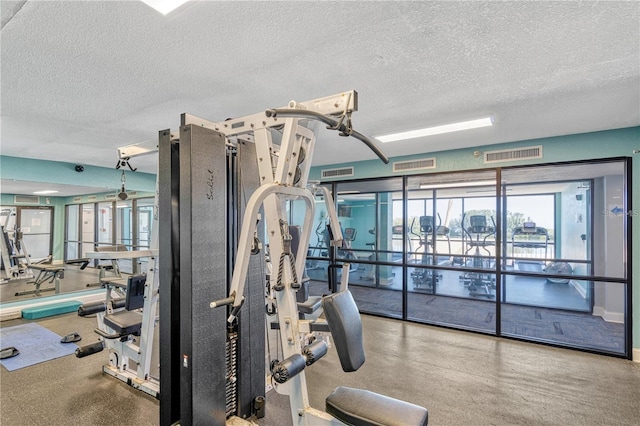 workout area with a textured ceiling and visible vents