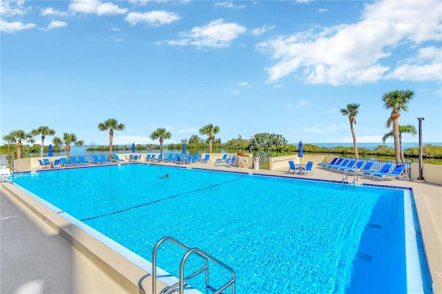 community pool with a water view and a patio