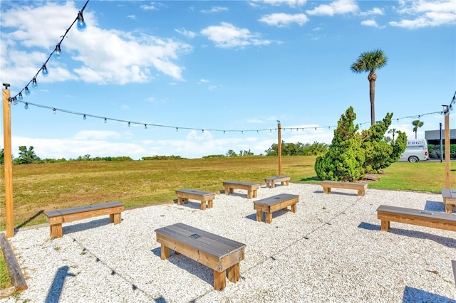 view of home's community featuring a rural view and a yard