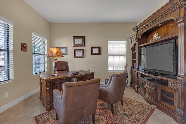 office space featuring light tile patterned floors, baseboards, and a wealth of natural light