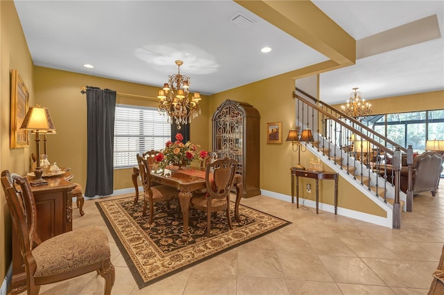 dining room featuring stairs, visible vents, plenty of natural light, and an inviting chandelier