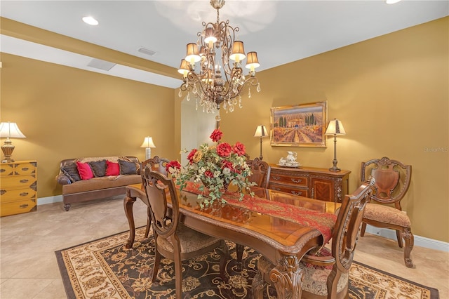 dining area featuring baseboards, visible vents, a chandelier, and tile patterned floors