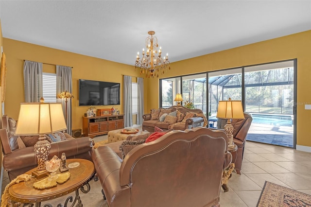 living area featuring light tile patterned floors, baseboards, and a chandelier