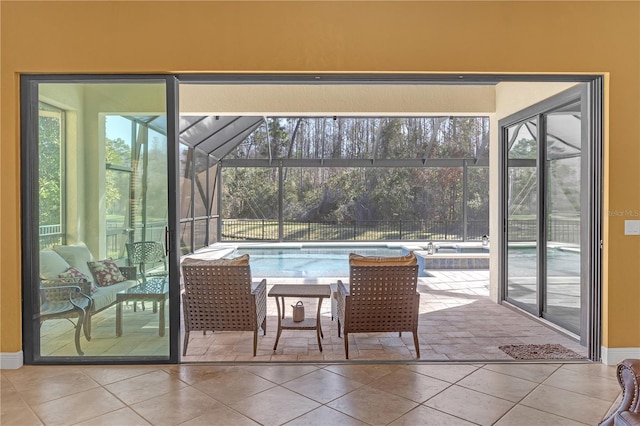 doorway with a sunroom and tile patterned flooring