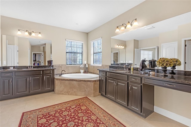 full bath with visible vents, tile patterned flooring, a sink, and a bath