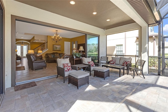 exterior space with a healthy amount of sunlight and an inviting chandelier