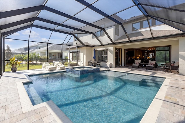 view of swimming pool with a lanai, a pool with connected hot tub, and a patio