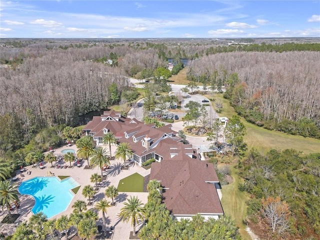 birds eye view of property with a view of trees