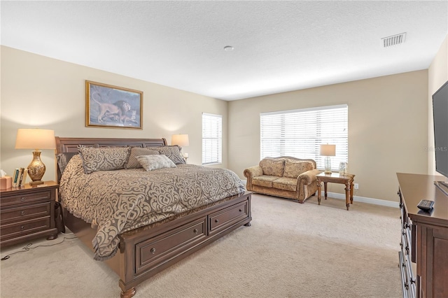 bedroom featuring light colored carpet, visible vents, and baseboards