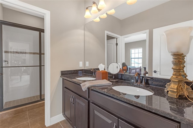 bathroom featuring a sink, a shower stall, and tile patterned floors