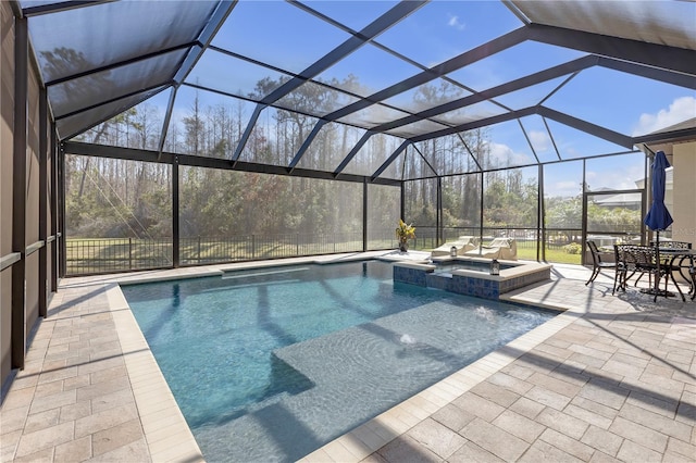 view of swimming pool featuring a lanai, a pool with connected hot tub, and a patio