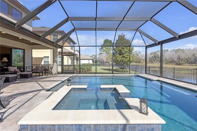 view of swimming pool with a patio area, a pool with connected hot tub, glass enclosure, and an outdoor living space