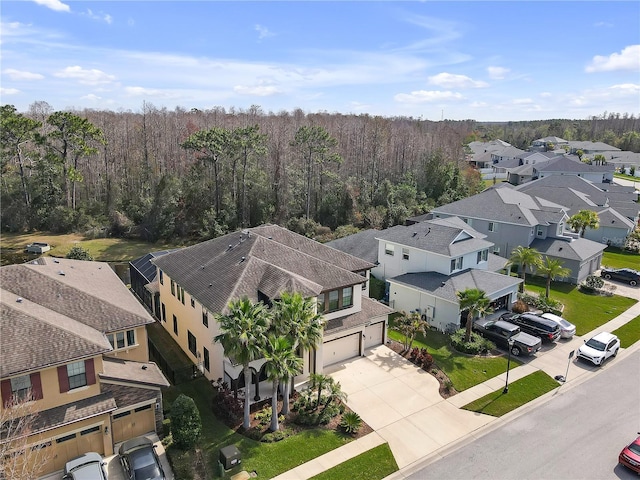 birds eye view of property featuring a residential view and a view of trees