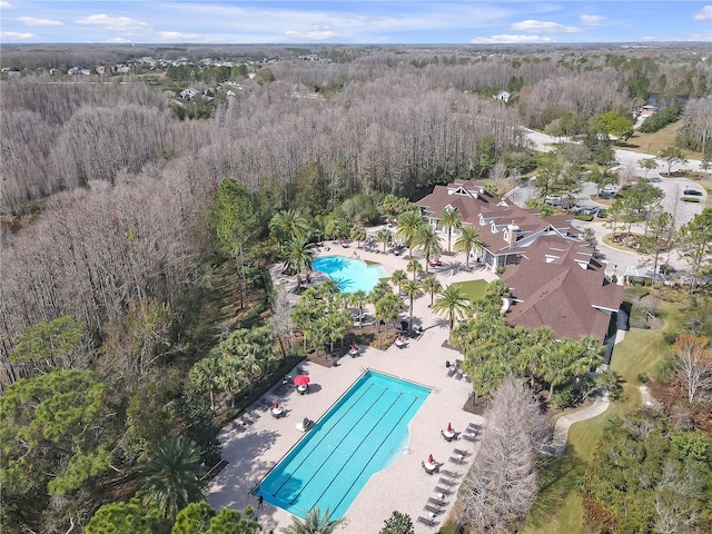 drone / aerial view with a wooded view