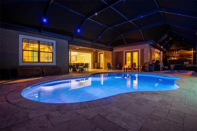 pool with a lanai and a patio area