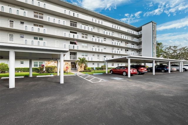 view of building exterior featuring covered parking