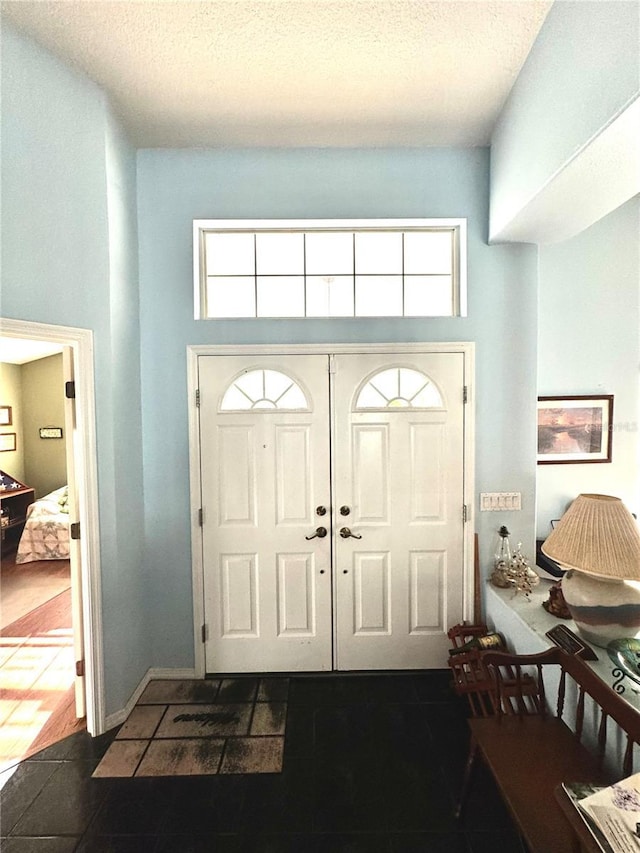 4797 N Lena Dr, Beverly Hills, FL 34465 - tiled foyer entrance with a textured ceiling, plenty of natural light, and a high ceiling