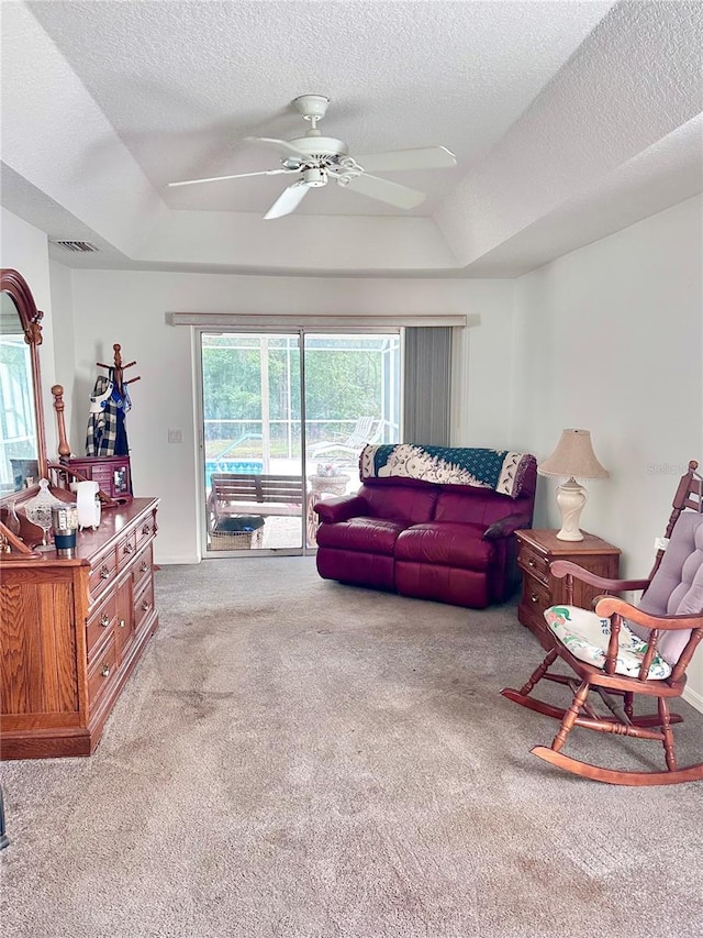 4797 N Lena Dr, Beverly Hills, FL 34465 - carpeted living room featuring a ceiling fan, a tray ceiling, a textured ceiling, and visible vents