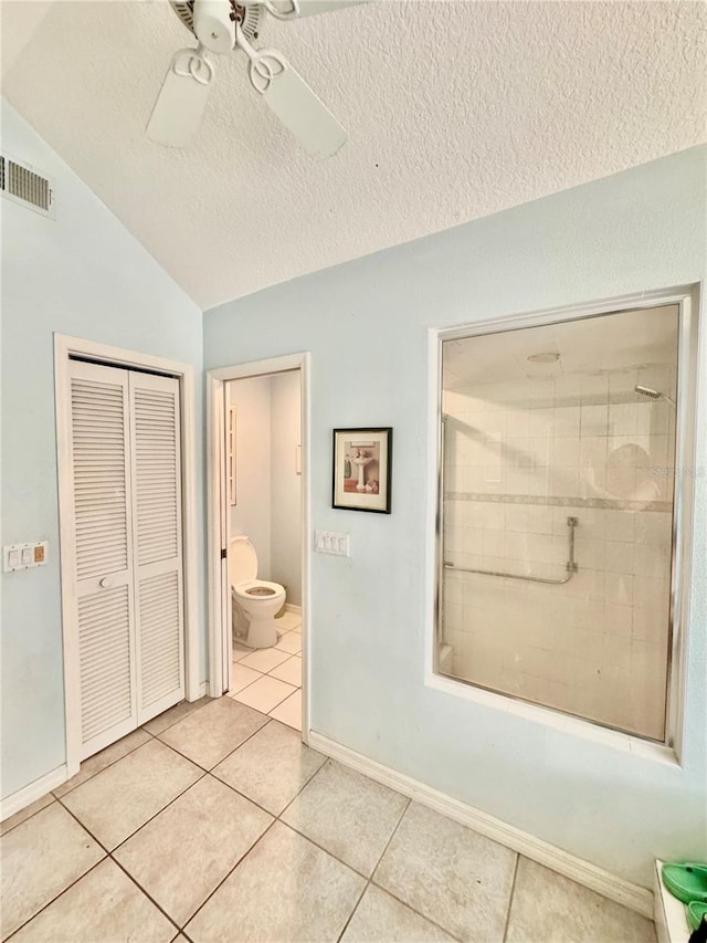 4797 N Lena Dr, Beverly Hills, FL 34465 - bathroom featuring tile patterned flooring, vaulted ceiling, visible vents, toilet, and a textured ceiling