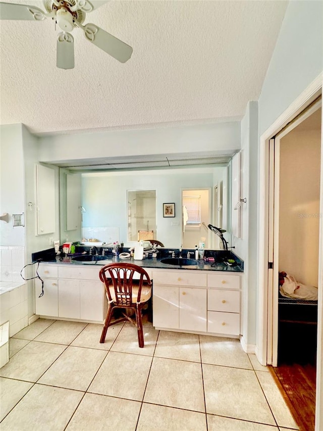 4797 N Lena Dr, Beverly Hills, FL 34465 - bathroom featuring a textured ceiling, tile patterned floors, ceiling fan, and a sink