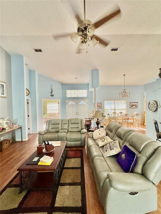 4797 N Lena Dr, Beverly Hills, FL 34465 - living area featuring wood finished floors, a textured ceiling, visible vents, and ceiling fan with notable chandelier
