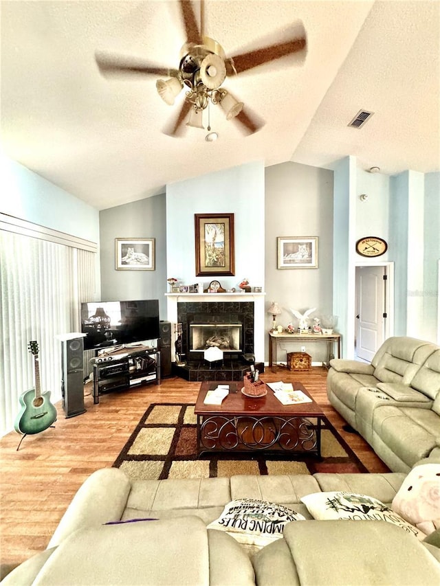 4797 N Lena Dr, Beverly Hills, FL 34465 - living area featuring lofted ceiling, wood finished floors, visible vents, a ceiling fan, and a fireplace
