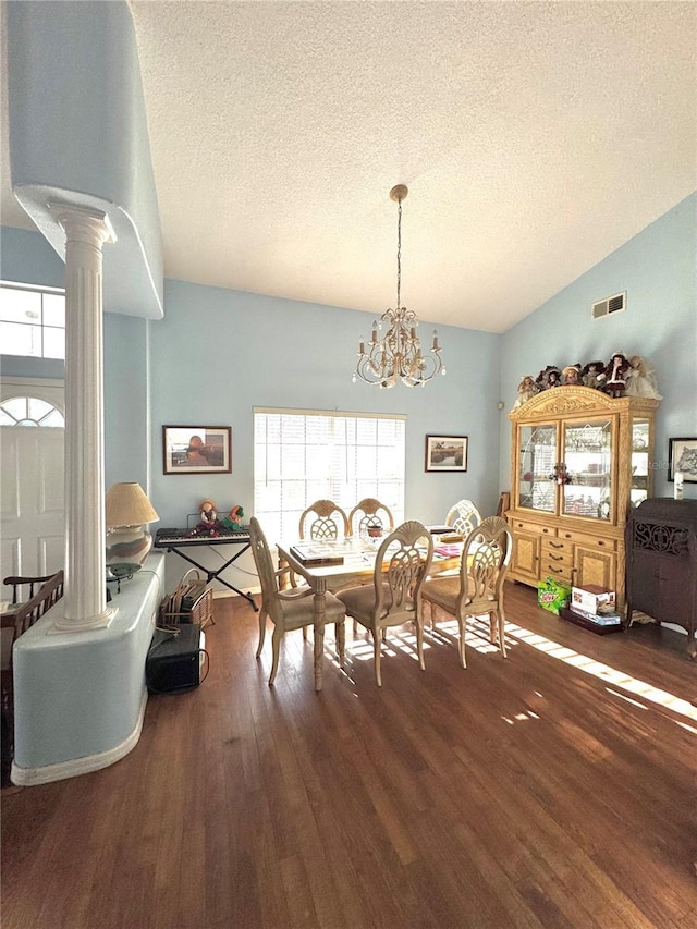 4797 N Lena Dr, Beverly Hills, FL 34465 - dining room featuring a textured ceiling, lofted ceiling, visible vents, and decorative columns