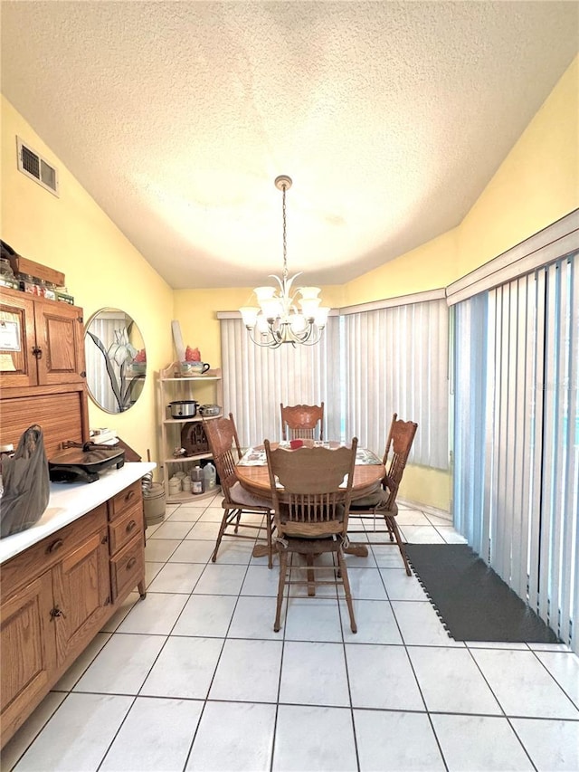 4797 N Lena Dr, Beverly Hills, FL 34465 - dining space featuring lofted ceiling, visible vents, light tile patterned floors, a textured ceiling, and a notable chandelier