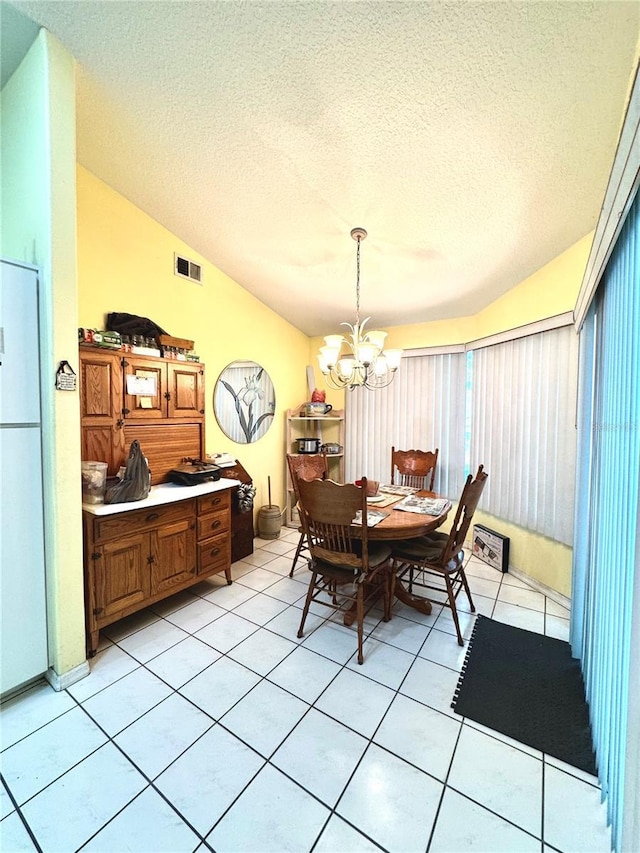 4797 N Lena Dr, Beverly Hills, FL 34465 - dining room with lofted ceiling, visible vents, light tile patterned floors, and an inviting chandelier