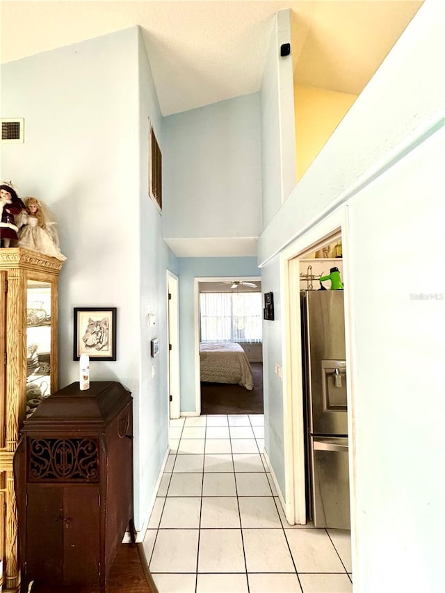 4797 N Lena Dr, Beverly Hills, FL 34465 - hallway featuring visible vents, a towering ceiling, baseboards, and light tile patterned floors