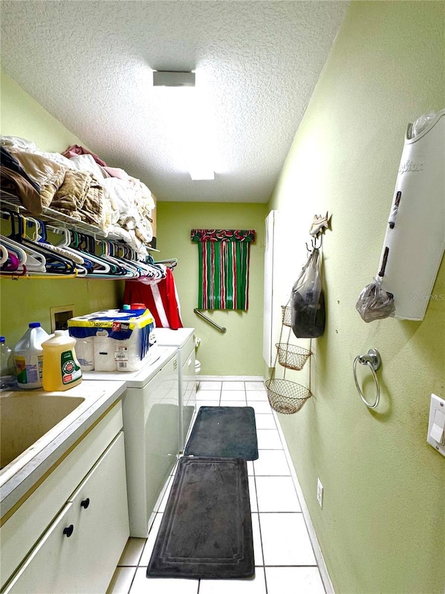 4797 N Lena Dr, Beverly Hills, FL 34465 - laundry room featuring washing machine and dryer, a textured ceiling, cabinet space, and light tile patterned floors