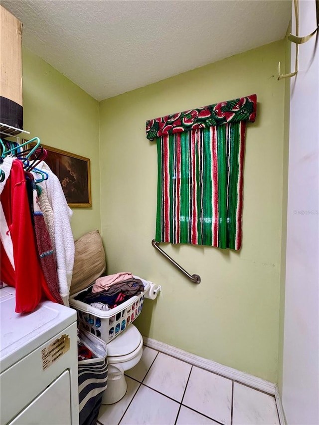 4797 N Lena Dr, Beverly Hills, FL 34465 - bathroom with tile patterned flooring, a textured ceiling, toilet, and baseboards