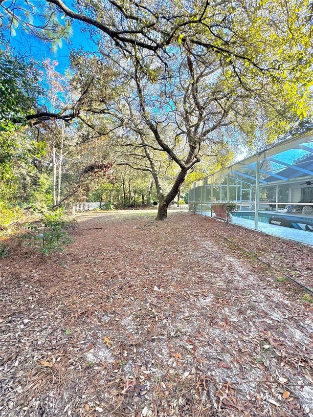 4797 N Lena Dr, Beverly Hills, FL 34465 - view of yard with a pool, fence, and glass enclosure