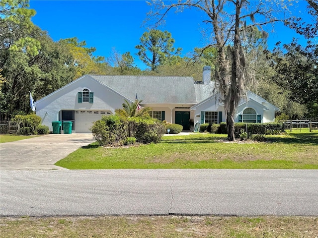 4797 N Lena Dr, Beverly Hills, FL 34465 - ranch-style house with a front lawn, a chimney, concrete driveway, and stucco siding