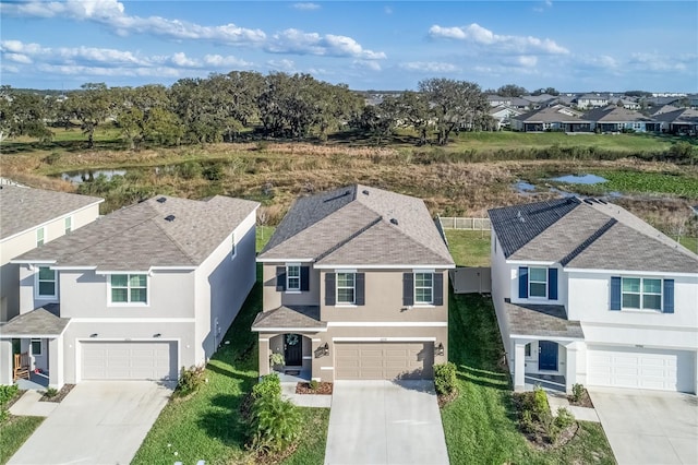 birds eye view of property featuring a water view and a residential view