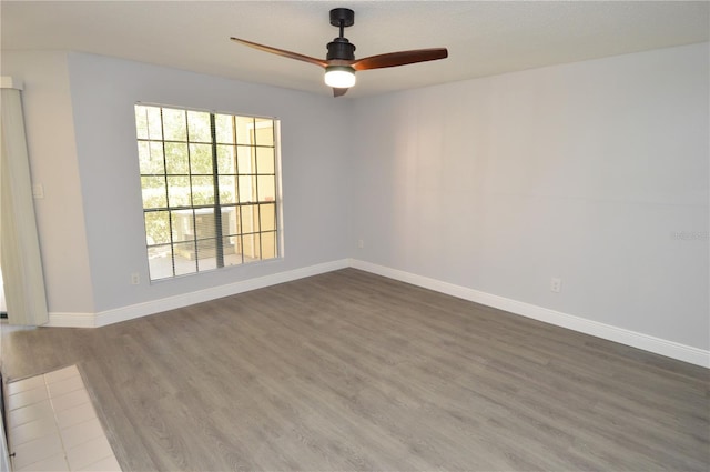 spare room featuring hardwood / wood-style flooring and ceiling fan