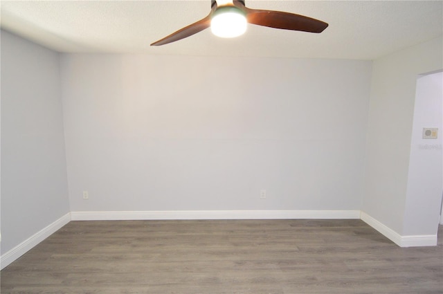 unfurnished room with a textured ceiling, ceiling fan, and wood-type flooring