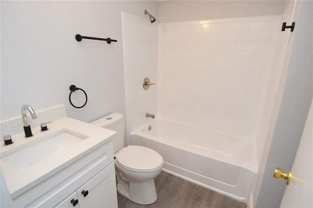 full bathroom with shower / washtub combination, vanity, toilet, and hardwood / wood-style floors